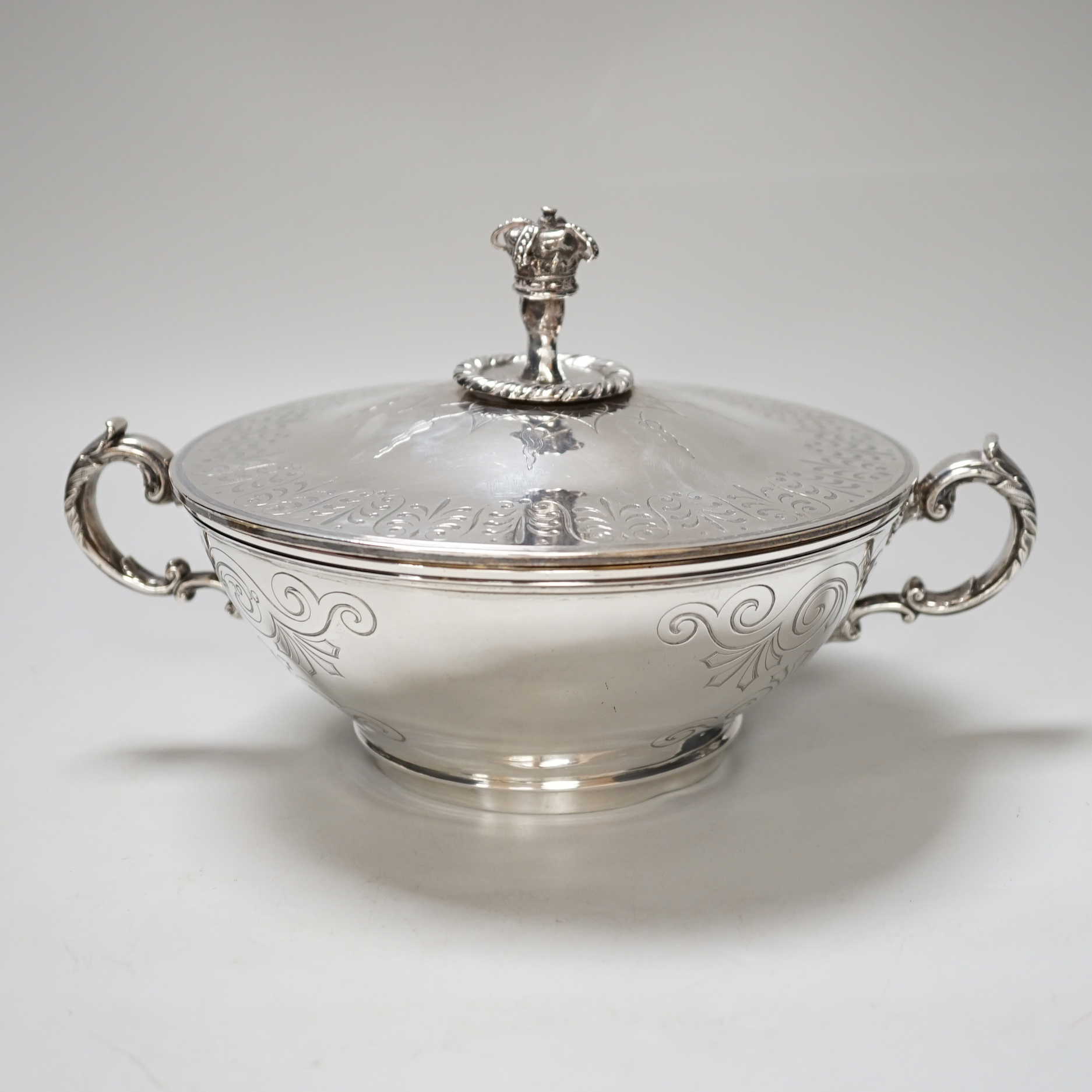A Victorian silver tureen and cover, with hand holding crown finial and stylised anthemion engravings, makers initials W.T, London 1867, 23cm over handle, 673 grams